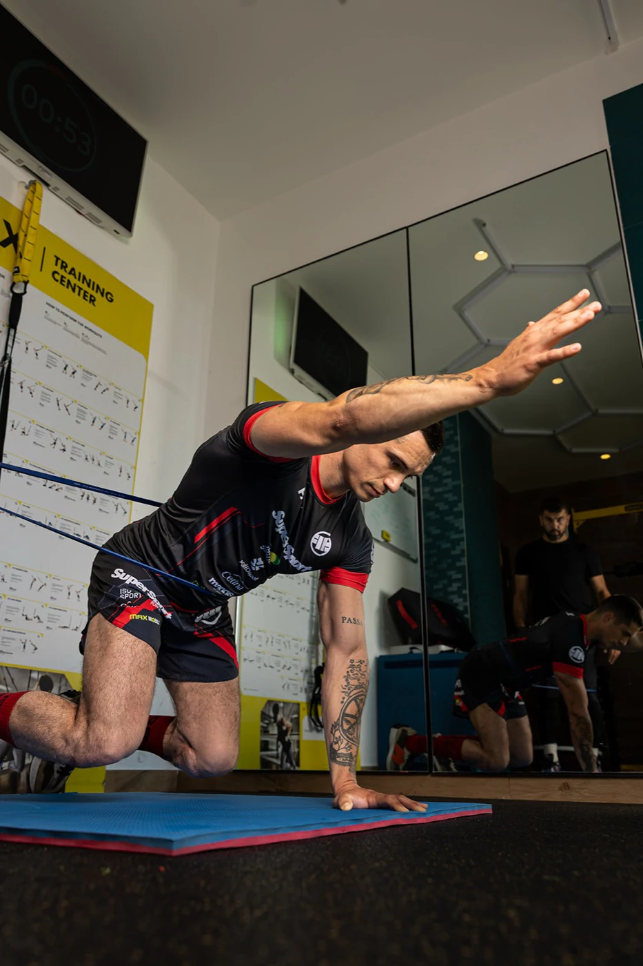Antonio doing a bodyweight exercise on a mat